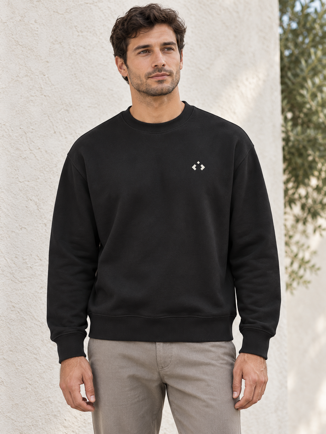 AI-supported styling illustration of an adult model in a black crewneck with an off-white geometric mark
